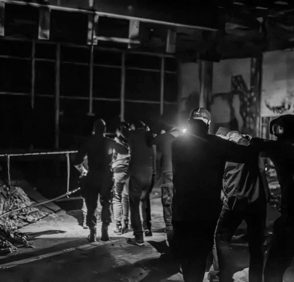 A collection of hiking gear including a backpack, map, and chair for winter expeditions.